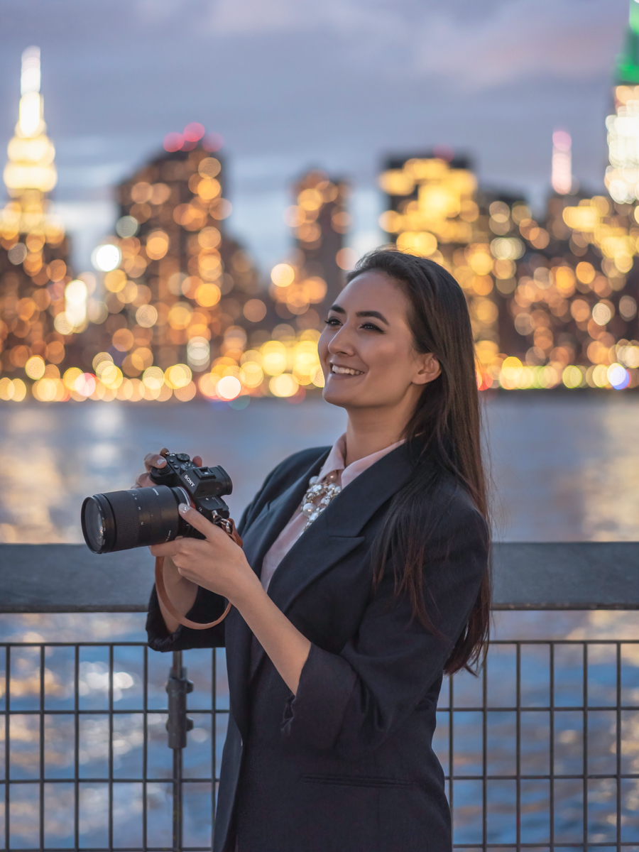 Personal branding photoshoot of Erin Donahue wearing a vintage Christian Dior blazer and holding a Sony a7iii at Gantry Plaza State Park.