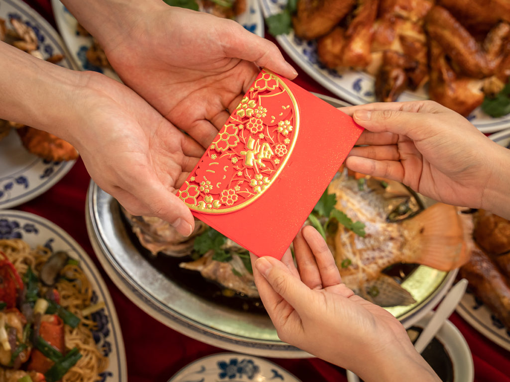 Not a stop motion food photography, but a still photo of handing off a red envelope for Lunar New Year.