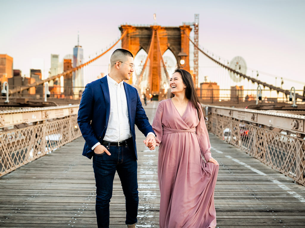 Sunrise couples portrait on the Brooklyn Bridge which is one of the best Brooklyn photography spots.