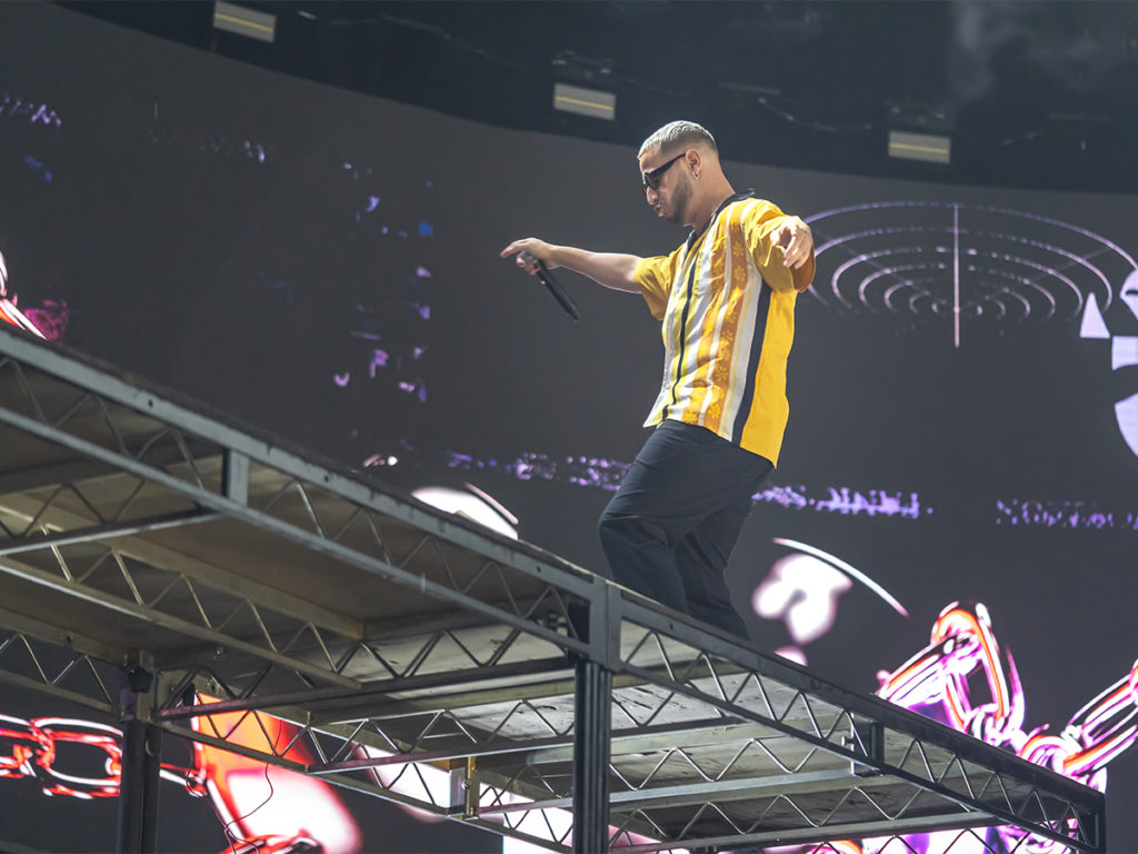 DJ Snake dancing on the table at the Brooklyn Mirage.