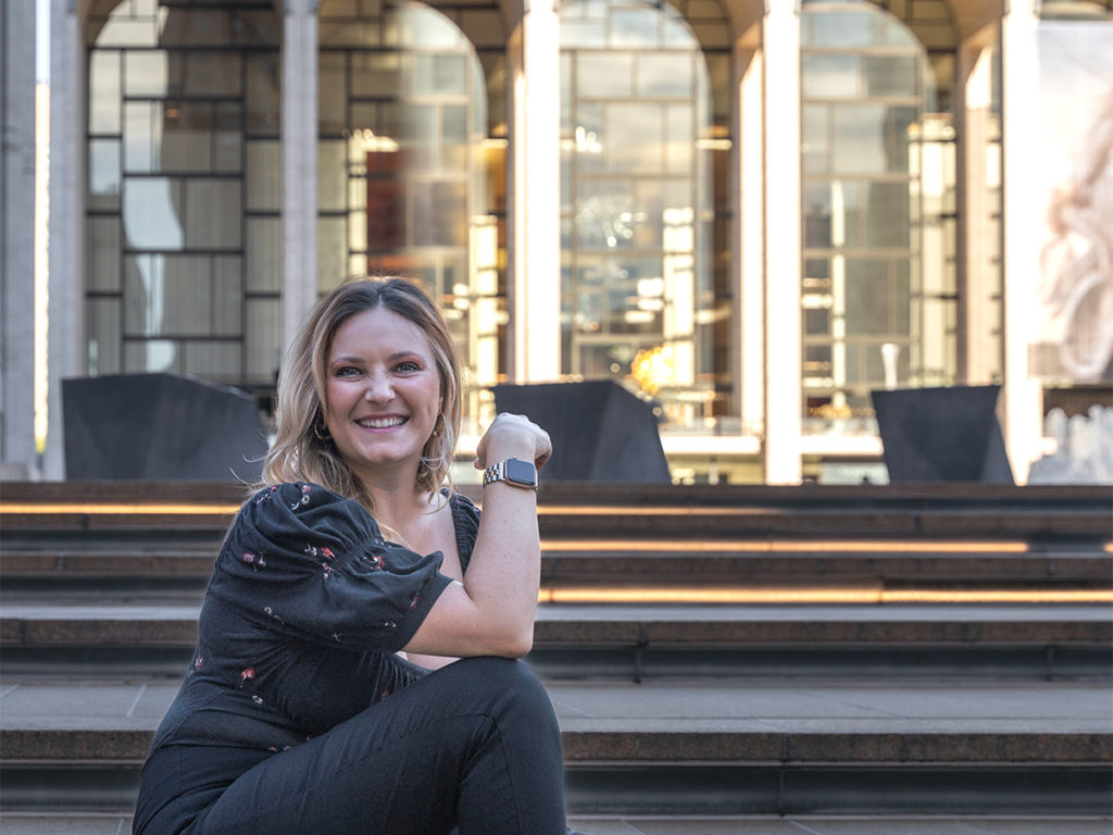 Smiling Elise Marks on the stairs of Lincoln Center for her personal branding photoshoot.