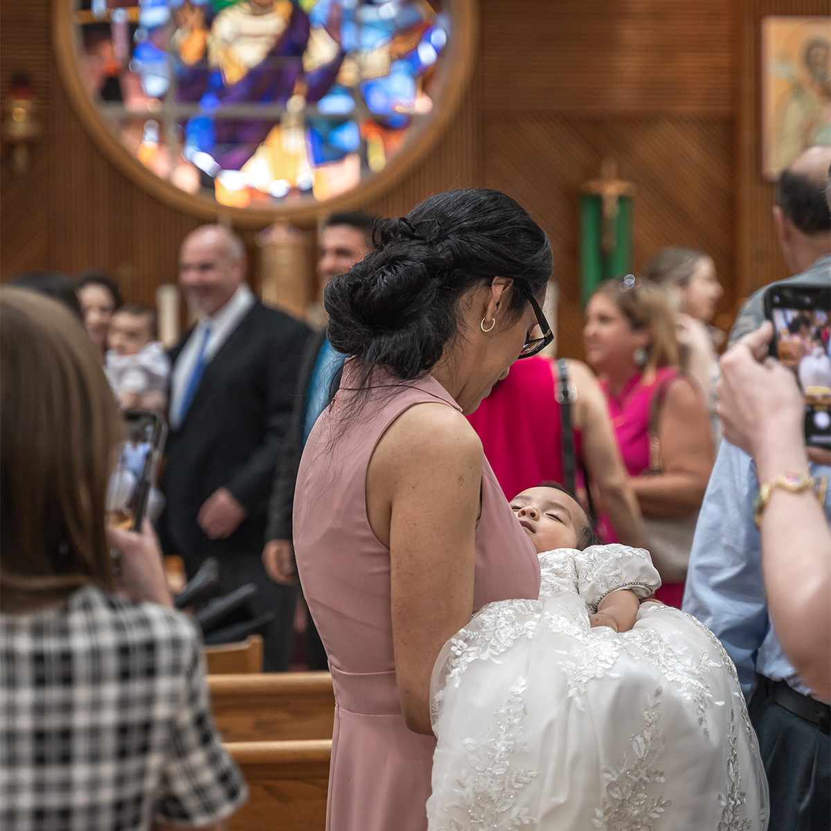 Photographing candid moments at a baby's baptism in Long Island.