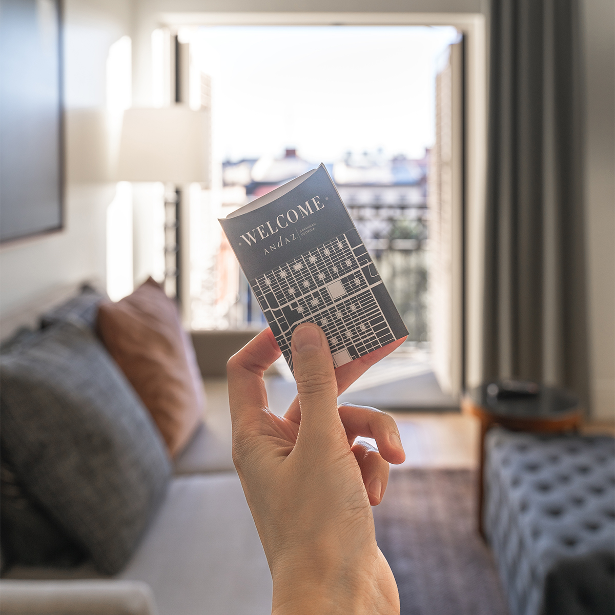 Hand holding hotel room keycard for Andaz Savannah.