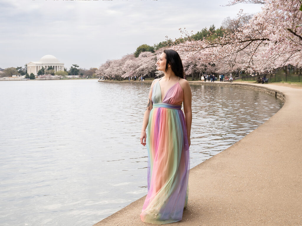 Walking along Tidal Basin in Washington D.C.  with a rainbow dress during peak cherry blossom season.