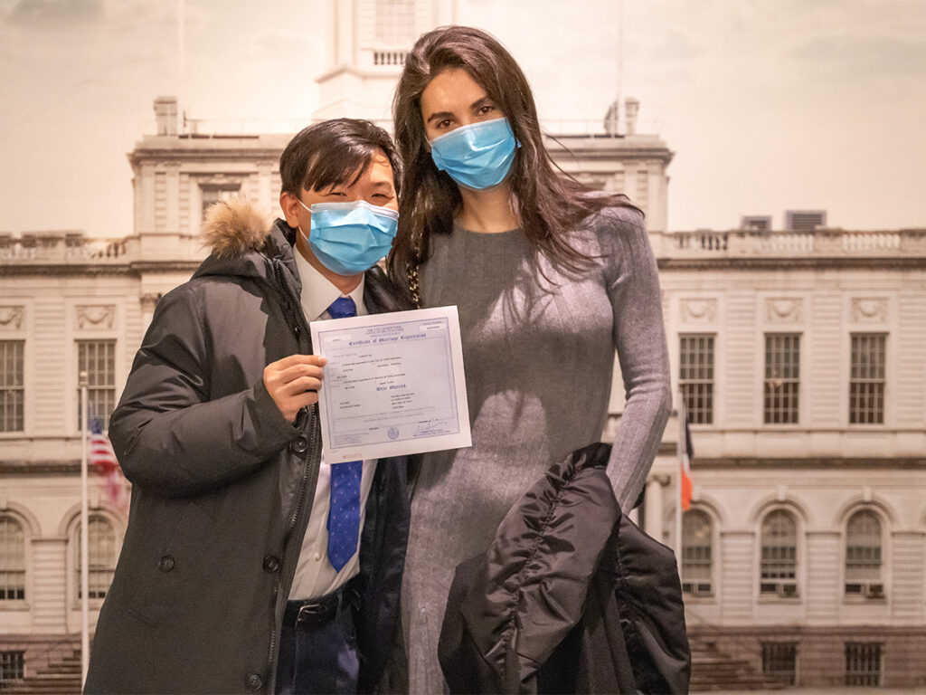 Officially married! Couple holds their marriage certificate from their NYC City Hall elopement.