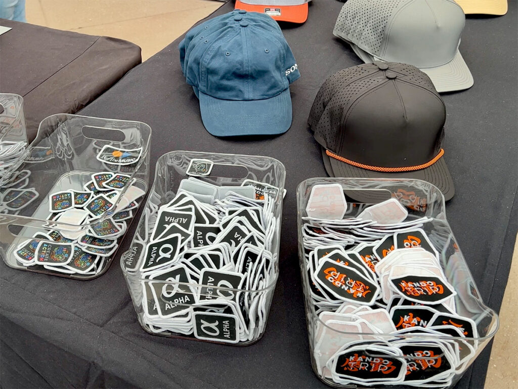 Sony Kando Trip swag table with branded hats and Alpha patches