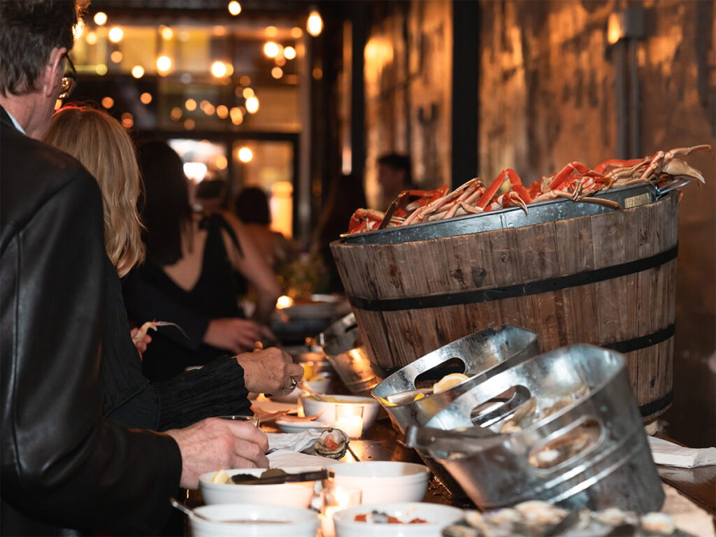 Family and friends line up to eat crab legs at Porta Jersey City.