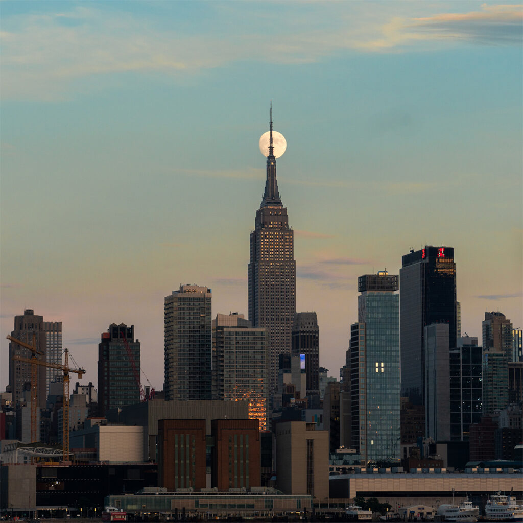 Empire State Building aligns with the supermoon nyc skyline.