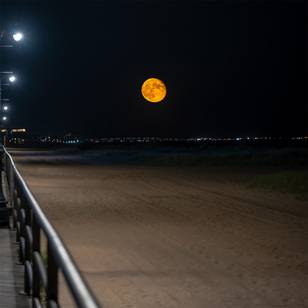 Supermoon rises over Brooklyn's Coney Island beach.