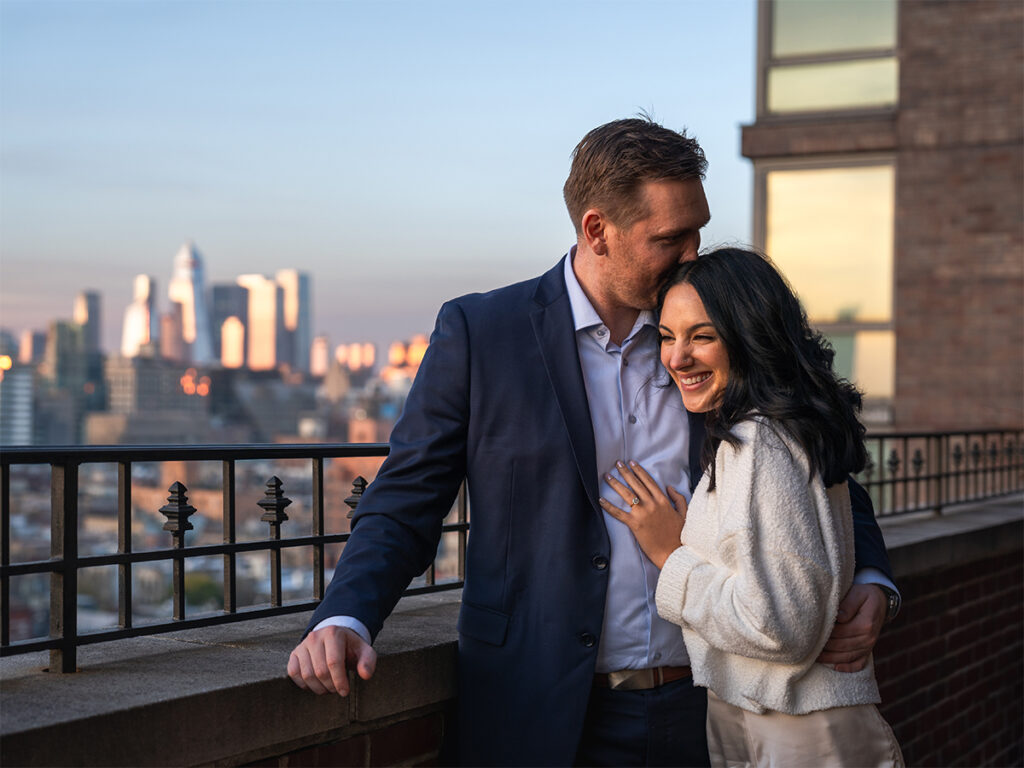 The newly engaged couple enjoy a moment together with the colorful sunset at The Ludlow Hotel.