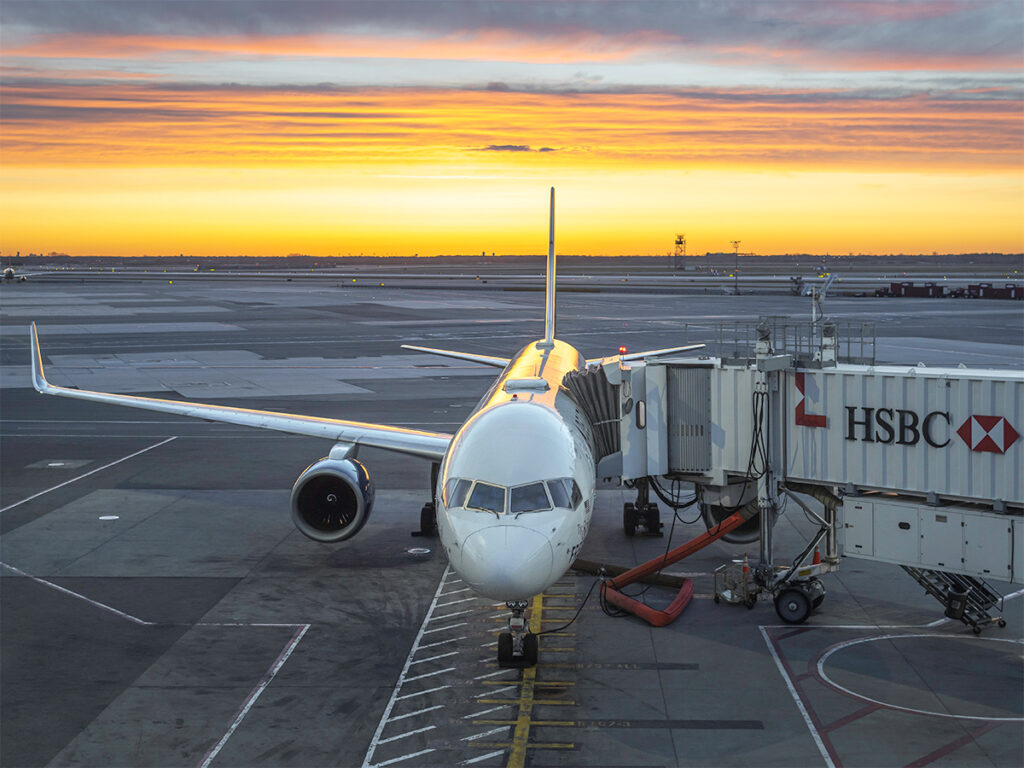 Plane with a colorful sunset in the background is a great way to start a two week carry-on packing adventure.