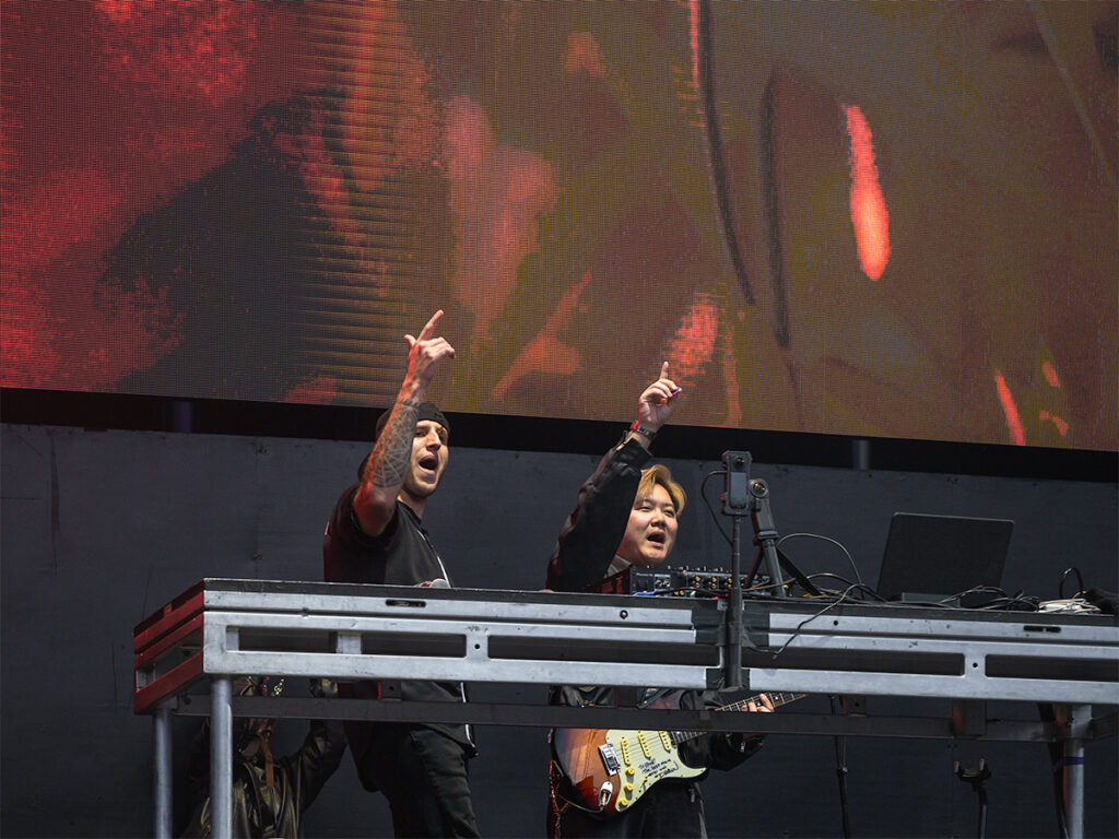 Illenium B2B Dabin. Both point their fingers to the audience at Head in the Clouds Festival in NY.