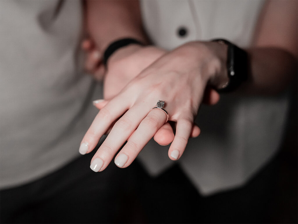 Detail shot of the diamond ring held by the newly engaged couple after their West Village proposal at Palma NYC.