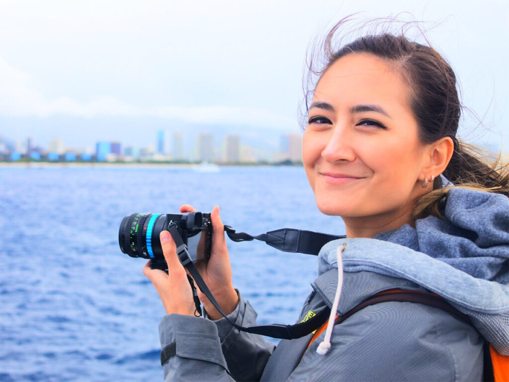 Holding a Sonya6000 while on the ocean. APS-C cameras allowed me to become a photography solopreneur.