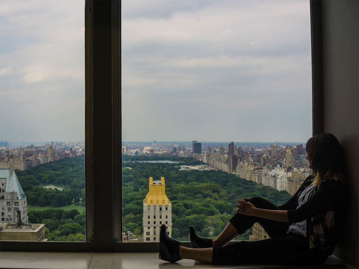 Sitting on a ledge and looking out over a multi-million dollar Central Park view from a corporate office window.