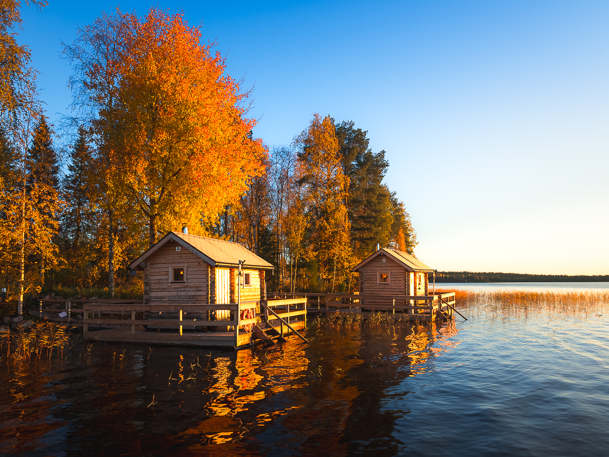 Fall foliage and golden hour paired with floating Finnish Sauna's are a beautiful sight to see during a Rovaniemi 7 day autumn itinerary.