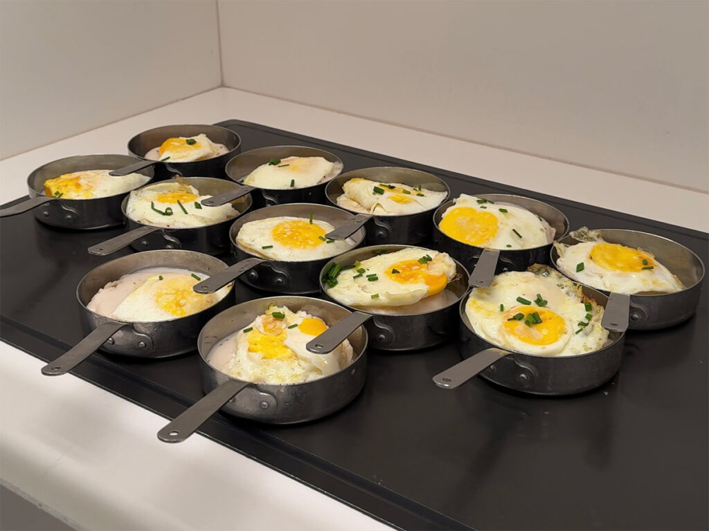 Multiple eggs in personal pans at the Capital One Lounge DFW.