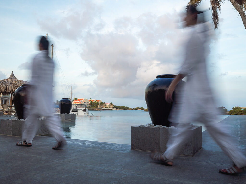 Motion blur walking at the infinity pool of Van der Valk Plaza Resort Bonaire.