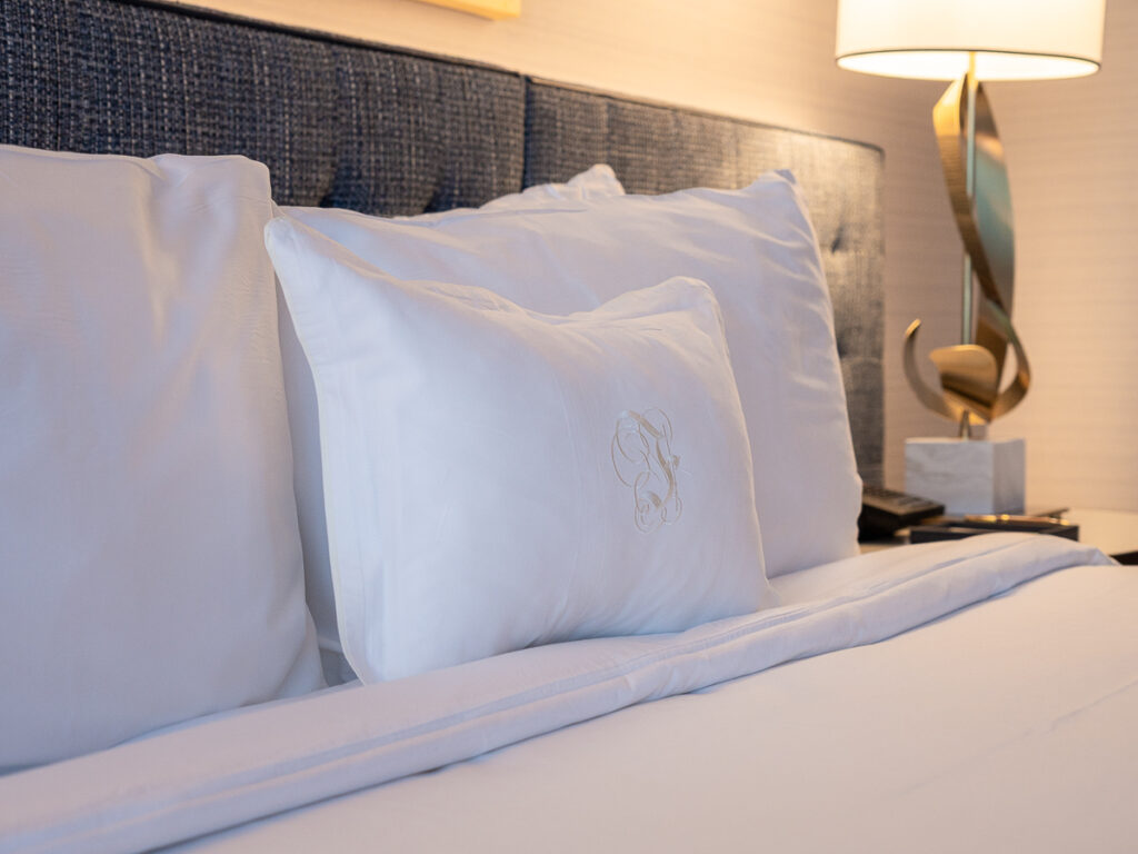 King sized bed with logo on the pillow at Fontainebleau Las Vegas hotel.