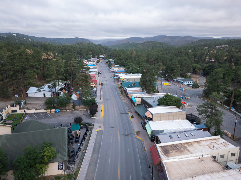 Aerial view of downtown Ruidoso, New Mexico, surrounded by pine forests and mountains