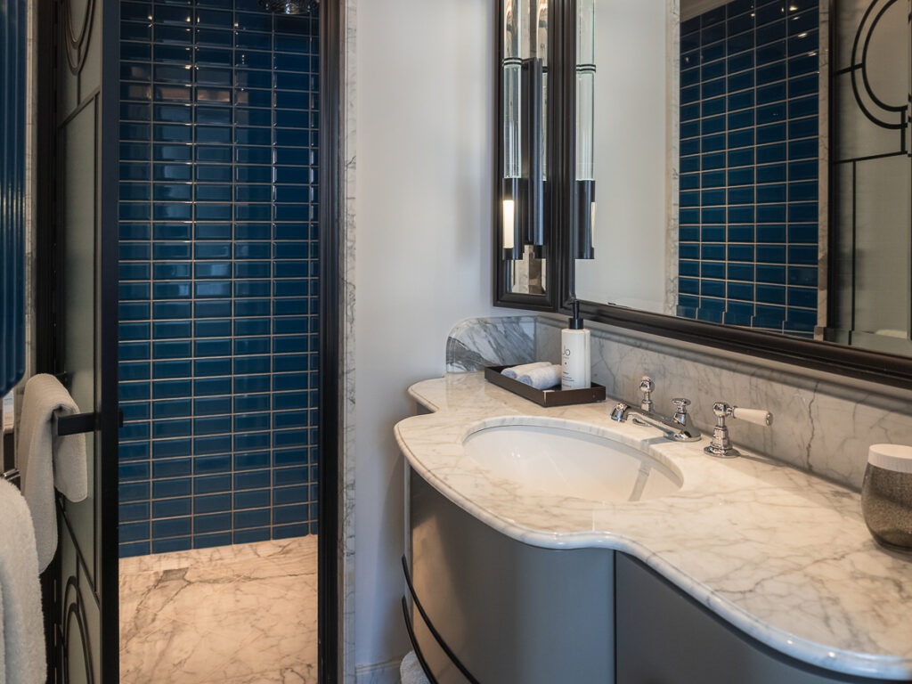 Inside the bathroom of the Great Scotland Yard Hotel with the turquoise bricks.