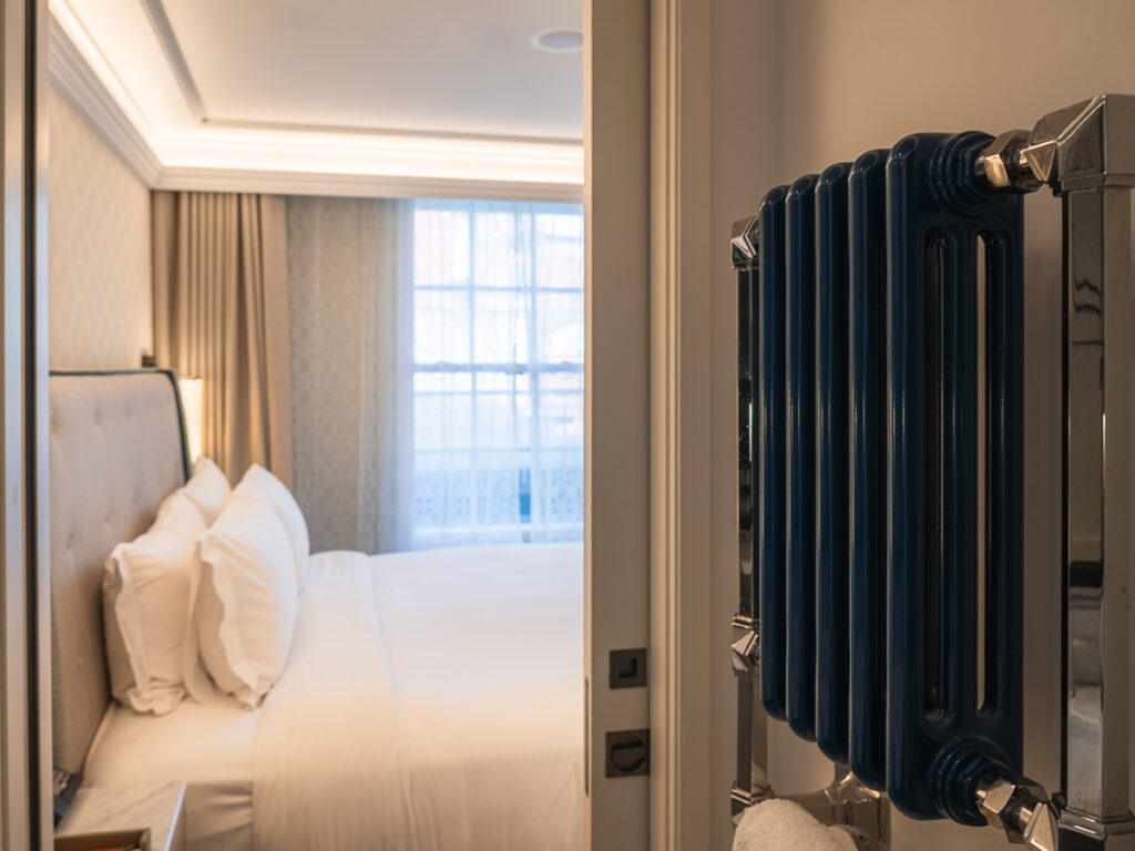 Inside the room of the Great Scotland Yard Hotel with the vintage turquoise radiator.