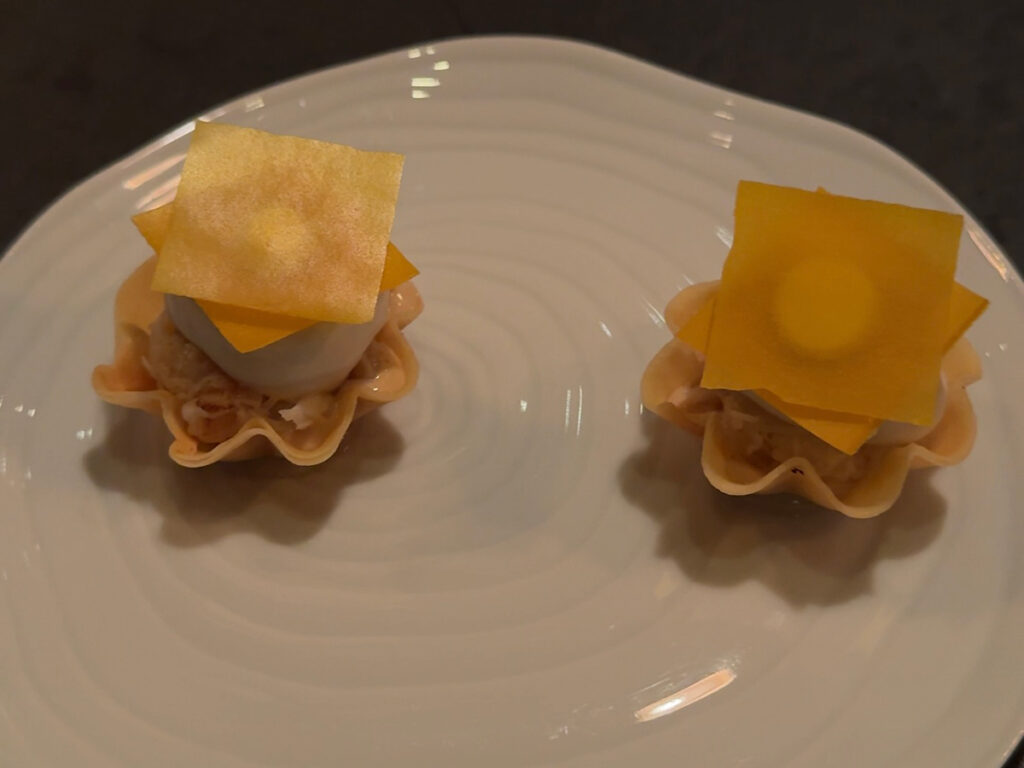 Two delicate tartlet bites with translucent citrus tuile from the Atera NYC tasting menu