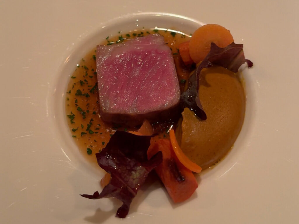 Perfectly cooked pink meat with glazed carrots and herb broth at Atera NYC