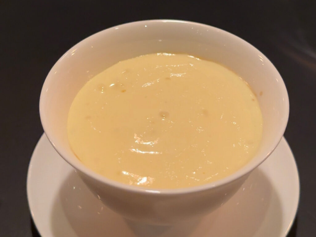 Silky warm soup course from the 13-course tasting menu at Atera NYC