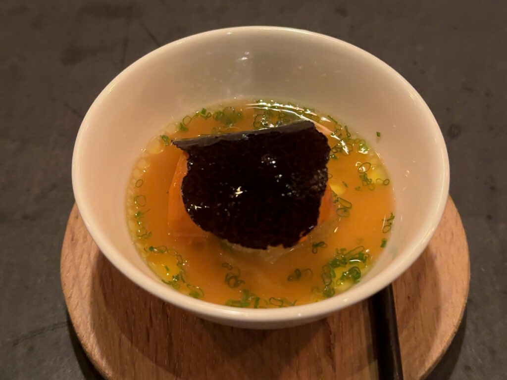 Black truffle and herb broth cup served during the Atera NYC tasting menu, Tribeca
