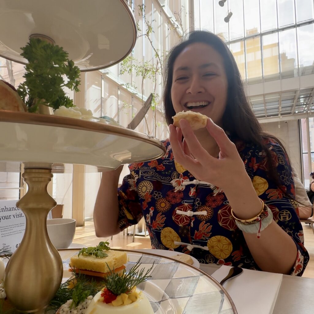 Afternoon tea at the Morgan Library NYC served on a classic three-tier stand with finger sandwiches and scones.