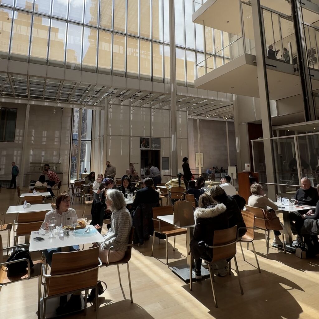 The Morgan Café dining room inside the Morgan Library & Museum NYC with floor-to-ceiling windows.