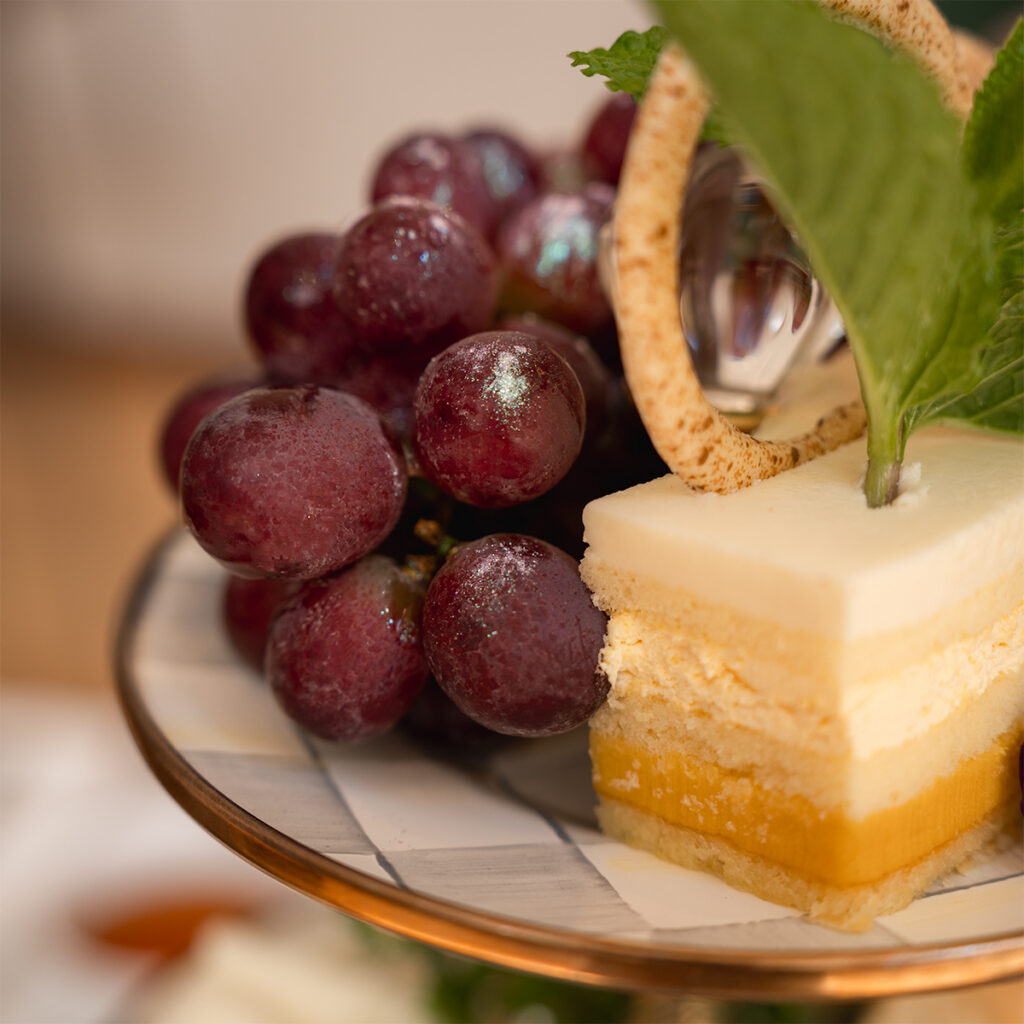 Glitter grapes and opera cake on the afternoon tea dessert tier at the Morgan Library NYC.