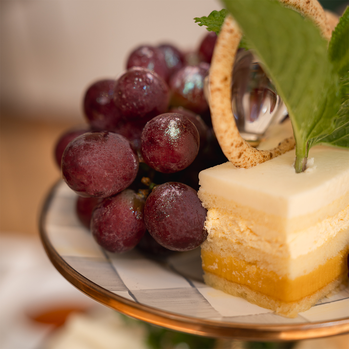 Glitter grapes and opera cake on the afternoon tea dessert tier at the Morgan Library NYC.