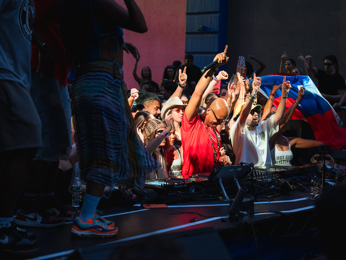 Francis Mercier DJing with the Haitian flag waving at Solèy NYC Industry City Brooklyn