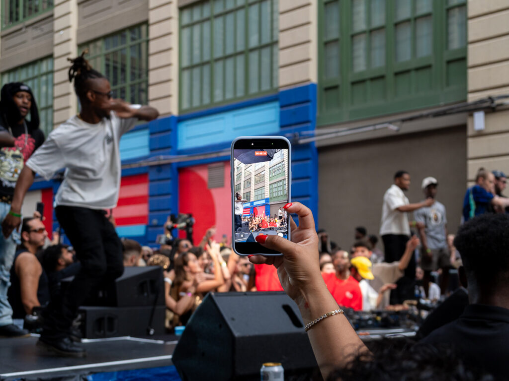 Crowd member filming Francis Mercier Solèy NYC at Industry City Brooklyn