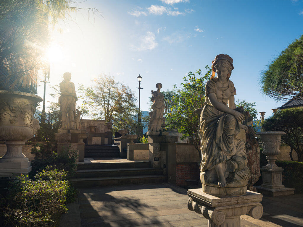 Classical stone statues lining the garden courtyard at Old England Manor in Qingjing, Taiwan.