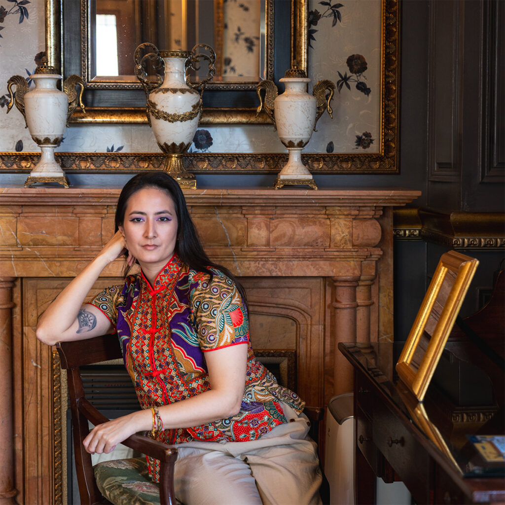 NIREDONAHUE posing by an antique marble fireplace inside Old England Manor in Qingjing, Taiwan.