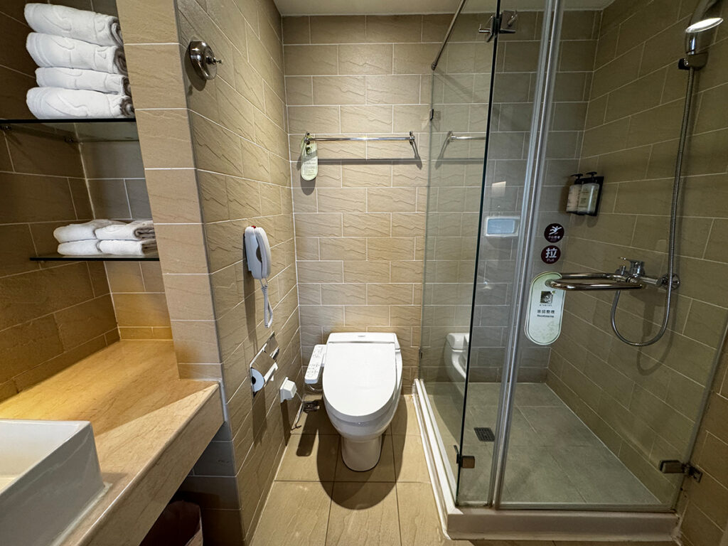 Glass-walled shower and toilet area at Caesar Park Hotel Kenting Taiwan.