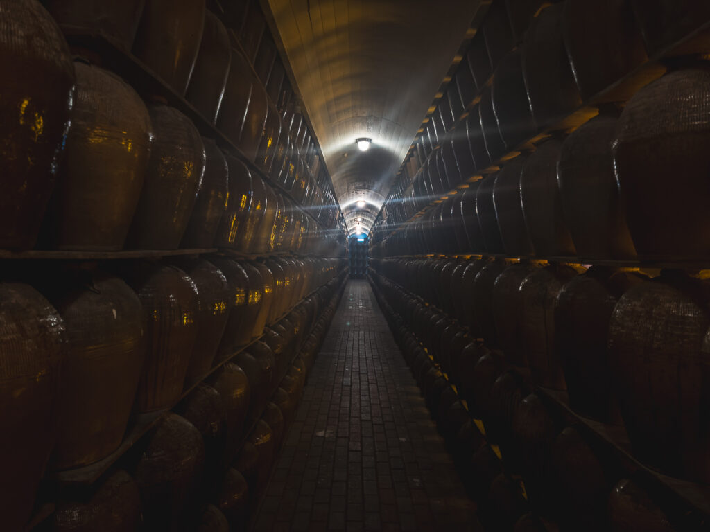 Rows of clay Shaohsing wine jars aging inside Puli Winery's cellar in Nantou County, Taiwan.