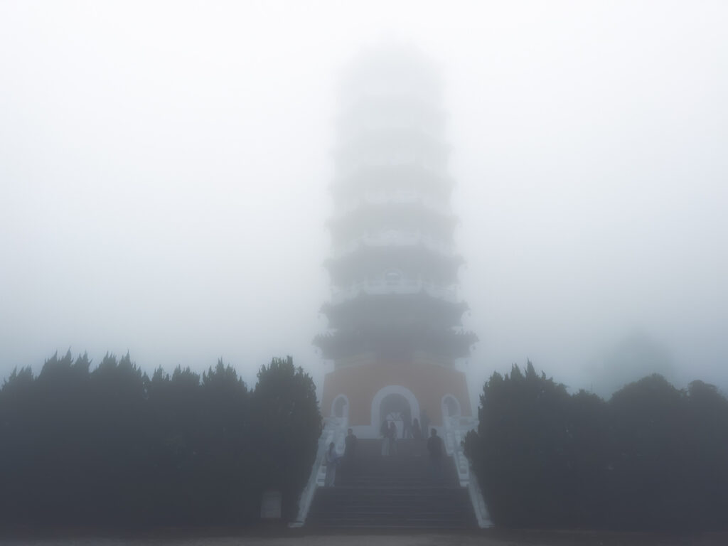 Ci'en Pagoda shrouded in thick fog near Sun Moon Lake, Nantou County, Taiwan.
