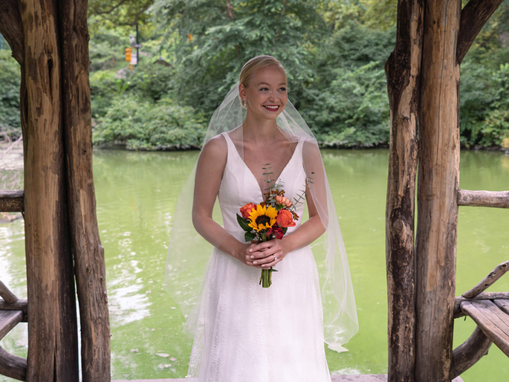 Traditional wedding portrait of Kat Gaffney under the pavilion of Wagner Cove.
