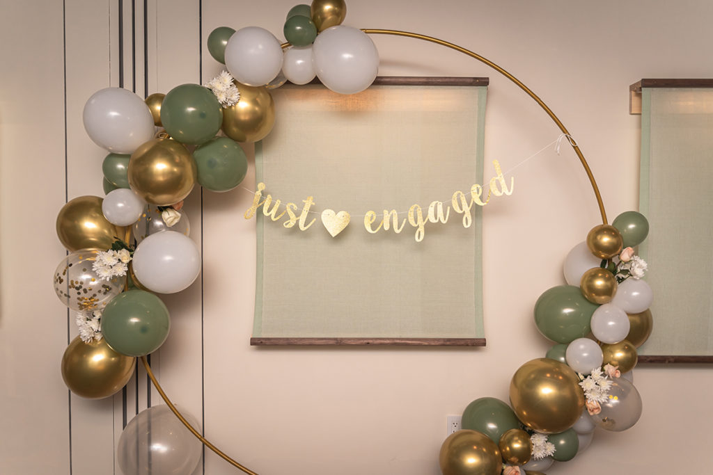 "Just engaged" banner framed with balloons in a private room at Rule of Thirds in Brooklyn.