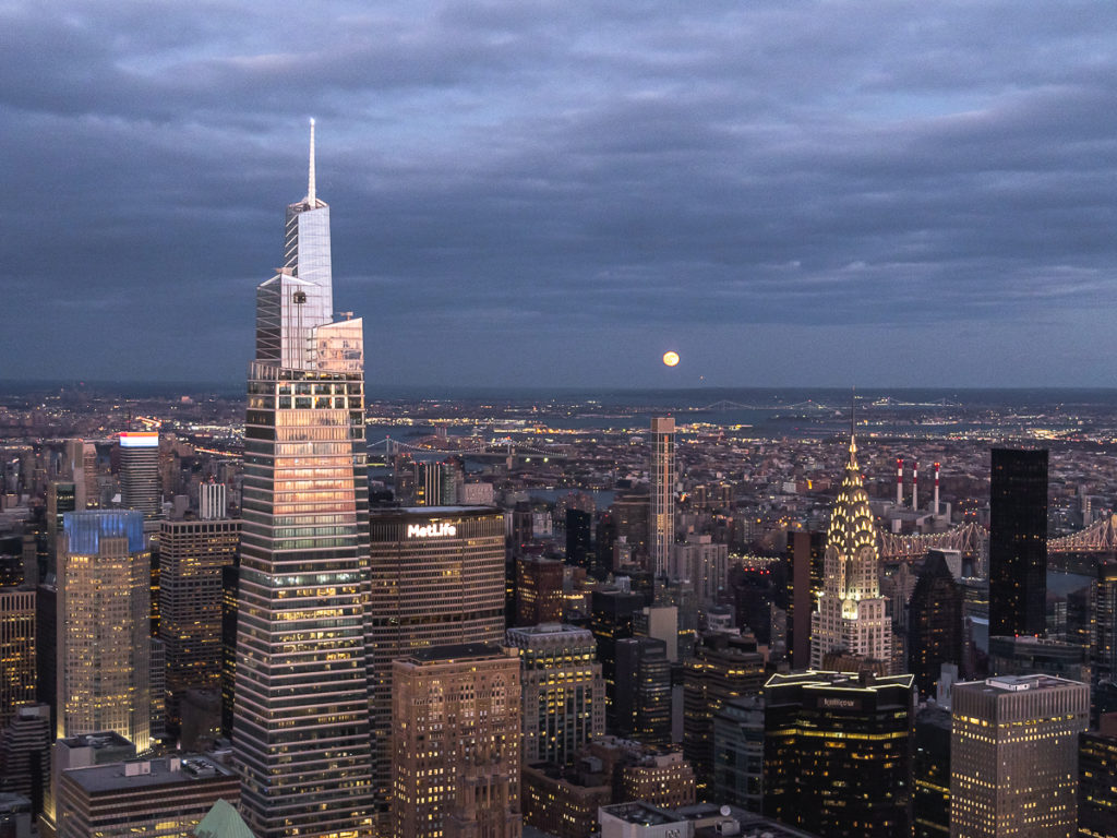 View of Summit One, Chrysler Building and moonrise from the Empire State Building observatory.