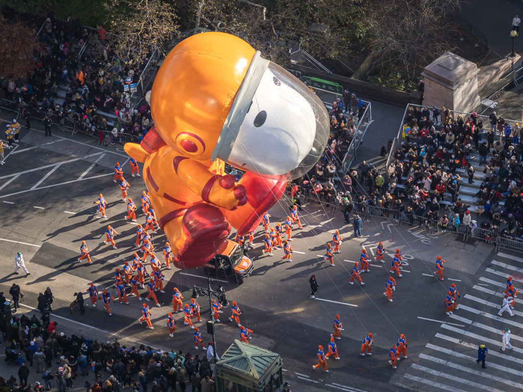 Orange astronaut Snoopy float seen from above at the Best Hotel To Watch Thanksgiving Day Parade