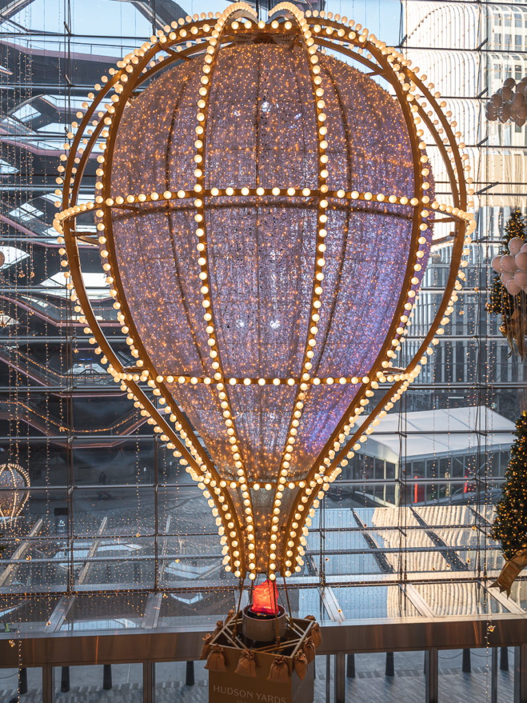 The center piece 32-foot hot air balloon is the centerpiece of Hudson Yards' Christmas Lights in NYC.