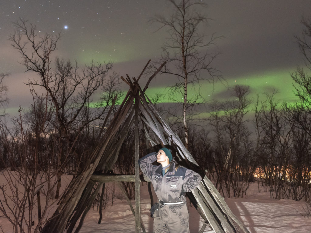 Light painting photography with the Northern Lights in the Lapland region of Abisko, Sweden.