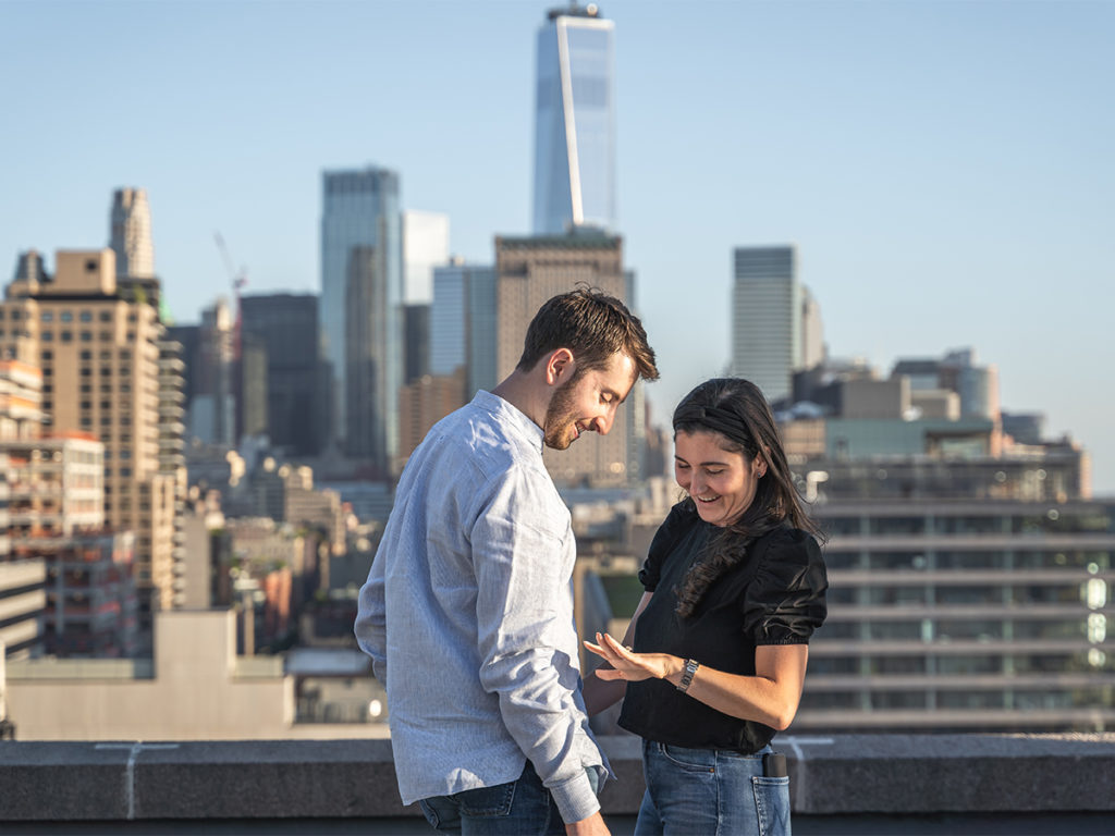 Jordan Zauderer and his fiancé, Casey inspect the diamond ring on top of a West Village rooftop.