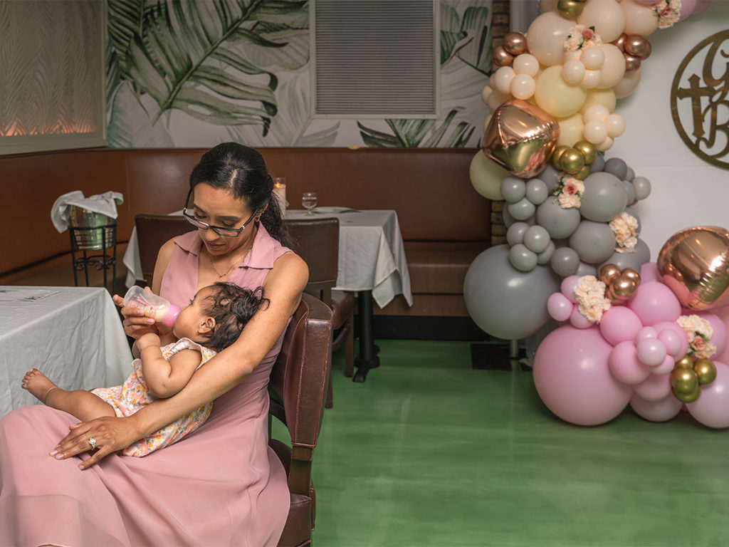 Tender moment of a mother and her baby at the reception of her christening.