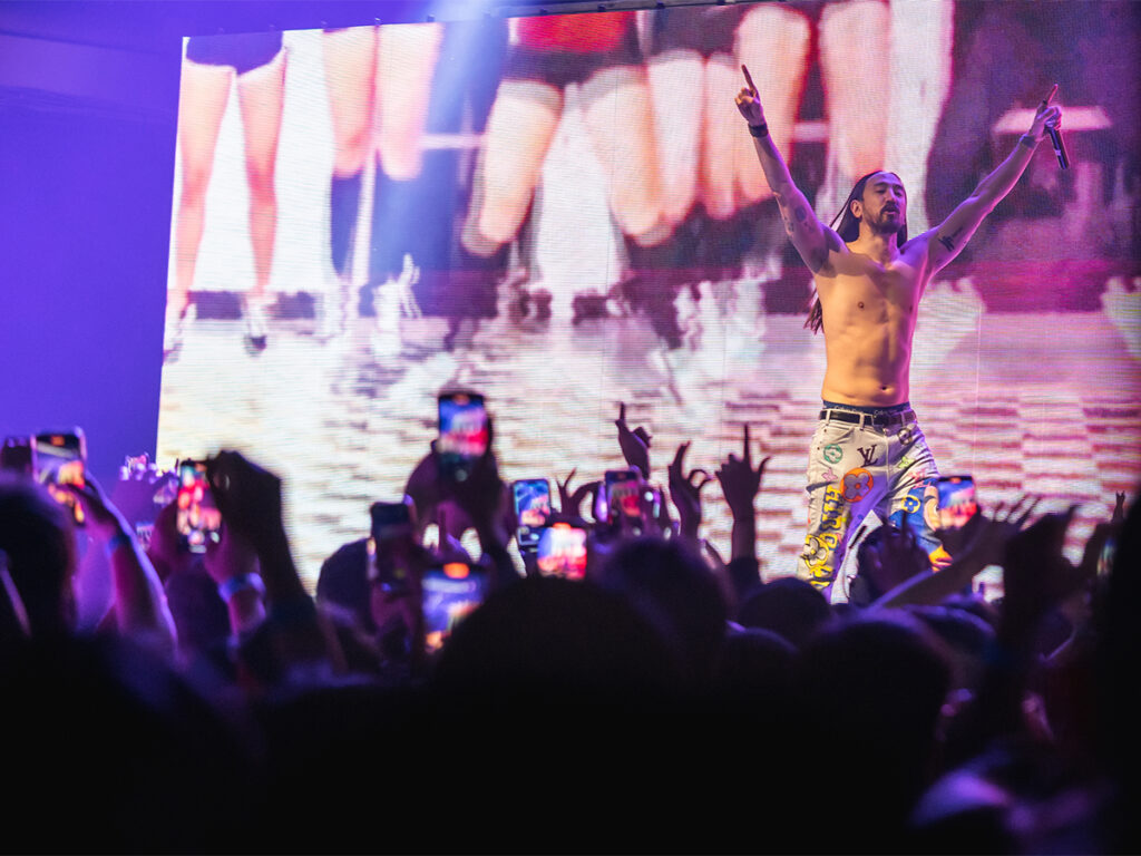 Steve Aoki walks shirtless across the stage at Terminal 5 during his concert.